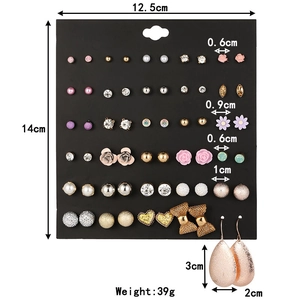 Detail view of 30 pairs mixed stud earrings set with dimensions on black card