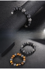 Macro view of tiger eye stones and lava beads with engraved stainless steel beads