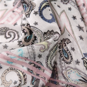 Detailed macro view of cotton linen scarf featuring paisley patterns and fabric texture