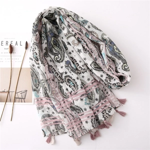 Detail of bohemian paisley print on cotton linen scarf with soft pink fringe tassels