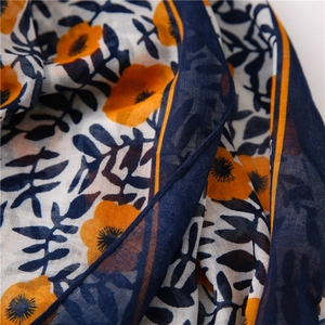 Detailed view of high-density cotton linen fabric with orange floral and navy paisley print