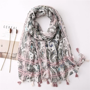 Detail of bohemian paisley print scarf with pink fringes and soft cotton linen texture