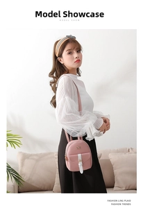 Detail showing pink mini backpack with golden bow hardware and contrast white straps