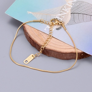 Detail of rose gold snake chain anklet with lobster clasp and K18 engraved tag