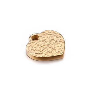 Minimalist golden heart pendant with unique hammered texture in polished stainless steel