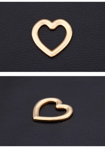 Detailed views of polished gold heart charms for DIY jewelry making on leather