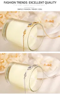 Detail of minimalist titanium steel bracelets with teardrop zircon in gold and silver finish