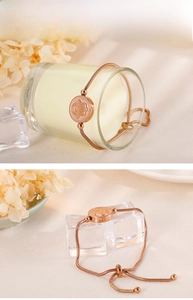 Detail of rose gold Hamsa Hand charm on adjustable stainless steel snake chain bracelet