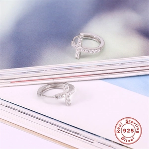 Close-up of S925 sterling silver cross hoop earrings with white micro-pave zircons