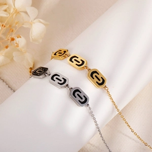 Fashionable hollow oval link bracelets in gold and silver finish with black enamel inlay