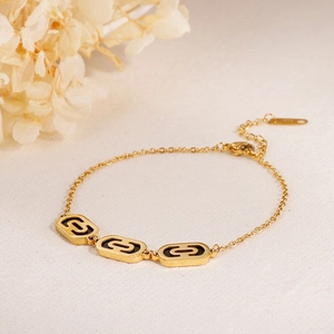 Elegant gold-plated chain bracelet with three hollow oval links and black enamel finish
