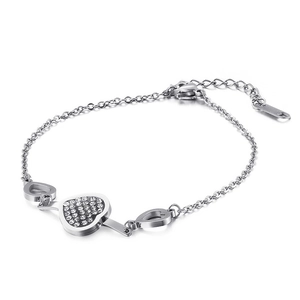 Silver stainless steel heart bracelet with sparkling crystals on minimalist white background