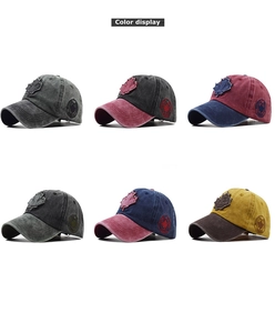 Close-up of distressed cotton baseball caps with embroidered maple leaf and side badges