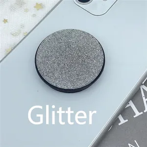 Foldable silver glitter pop-up socket phone stand attached to smartphone back