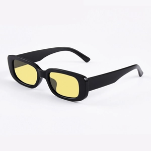Detail view of vintage black rectangle sunglasses with bright yellow tinted lenses