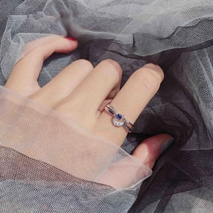 Sterling silver moon and star open ring with blue gemstone and diamonds on hand
