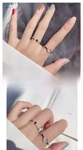 Detail of silver moon ring set with blue crystal and adjustable open bands for women