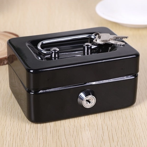 Mini black metal cash box with handle and key lock on a natural wooden table