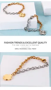 Gros plan du bracelet trèfle en acier bicolore avec maillons dorés et argentés