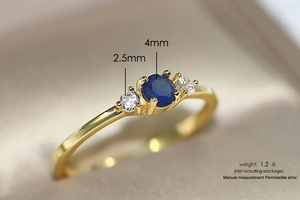 Detailed macro view of gold ring with 4mm blue sapphire and 2.5mm zircon accents