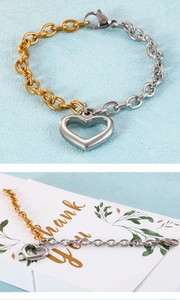 Detail of two-tone gold and silver heart bracelet with hollow pendant on gift card