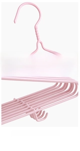 Macro shot of reinforced hook base and non-slip notches on pink dipped metal hanger