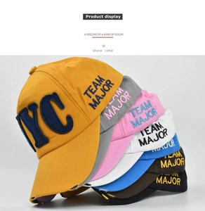 Detailed stack of vintage distressed cotton baseball caps with NYC embroidery in multiple colors