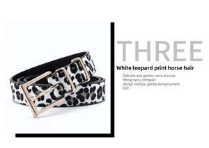 Macro shot of white leopard print pony hair leather belt with a gold metal buckle
