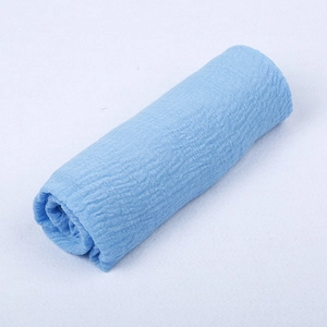 Detailed texture of blue cotton linen crinkle scarf with soft pleated fabric surface