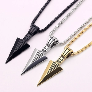 Detailed view of men's arrow pendant necklaces in black, silver, and gold finishes