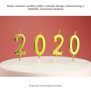 Close-up of golden number 2 and 0 candles with metallic finish and support pins