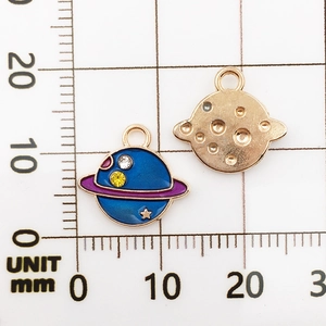Detail view of gold planet charms with blue enamel and rhinestones on a 15mm scale