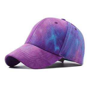 Detail view of purple and blue tie-dye cotton baseball cap with twill texture and curved brim