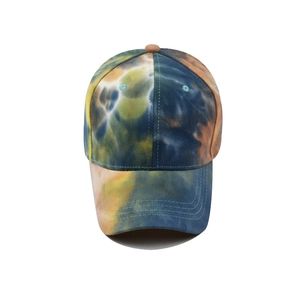 Detail of multi-color tie-dye baseball cap featuring reinforced brim stitching and air vents