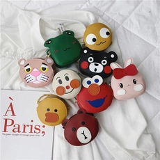 Collection of various cartoon character mini round pouches on a white fabric background