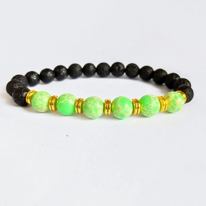 Detail of lava rock beads and green marble stones with gold spacers on elastic bracelet