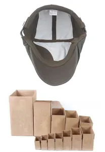Detail of vintage cotton newsboy cap interior and protective corrugated cardboard packaging