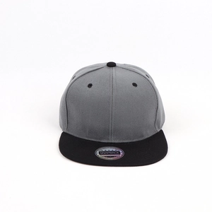 Close-up of dual-tone snapback cap featuring dark grey crown and black flat brim with sticker