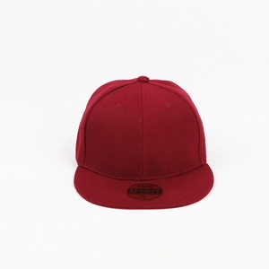 Detail view of red snapback hat with round size sticker on flat brim and six-panel crown