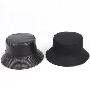 Reversible black PU leather and cotton bucket hats with a minimalist round dome design