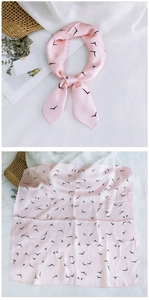 Detail of pink satin square scarf with black bird print shown tied and laid flat