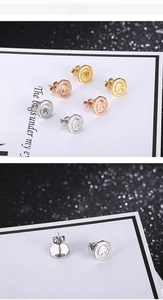 Detailed macro view of octagonal coin relief stud earrings in gold, silver and rose gold