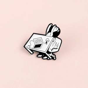 Enamel lapel pin featuring a minimalist black and white figure stretching at a desk
