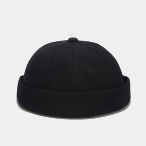 Detail of a vintage black cotton miki hat featuring twill texture and a round brimless crown