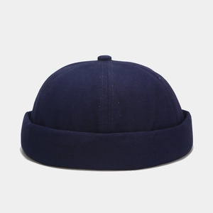 Detailed view of the dark blue docker hat showing cotton twill fabric and rolled brim