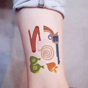 Detailed view of children's western cowboy temporary tattoos on skin featuring cacti and revolvers