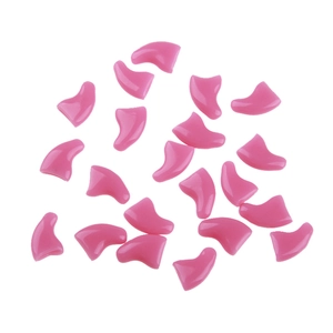 Macro display of 20 pieces bright pink silicone cat nail caps on a clean white background