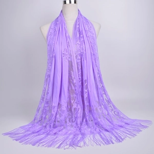 Close-up of lavender lace shawl featuring intricate hollow patterns and fine fringe trim