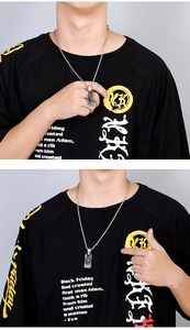 Close-up of a men's vintage stainless steel dragon pendant necklace on a male model