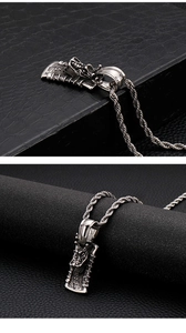 Close-up of vintage stainless steel dragon head pendant on a twist rope chain
